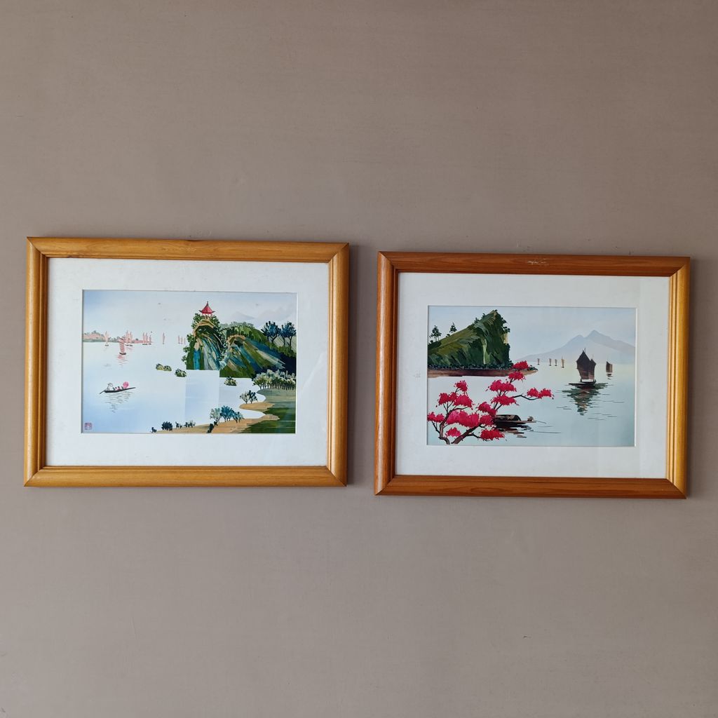 A pair of framed oriental scenes.